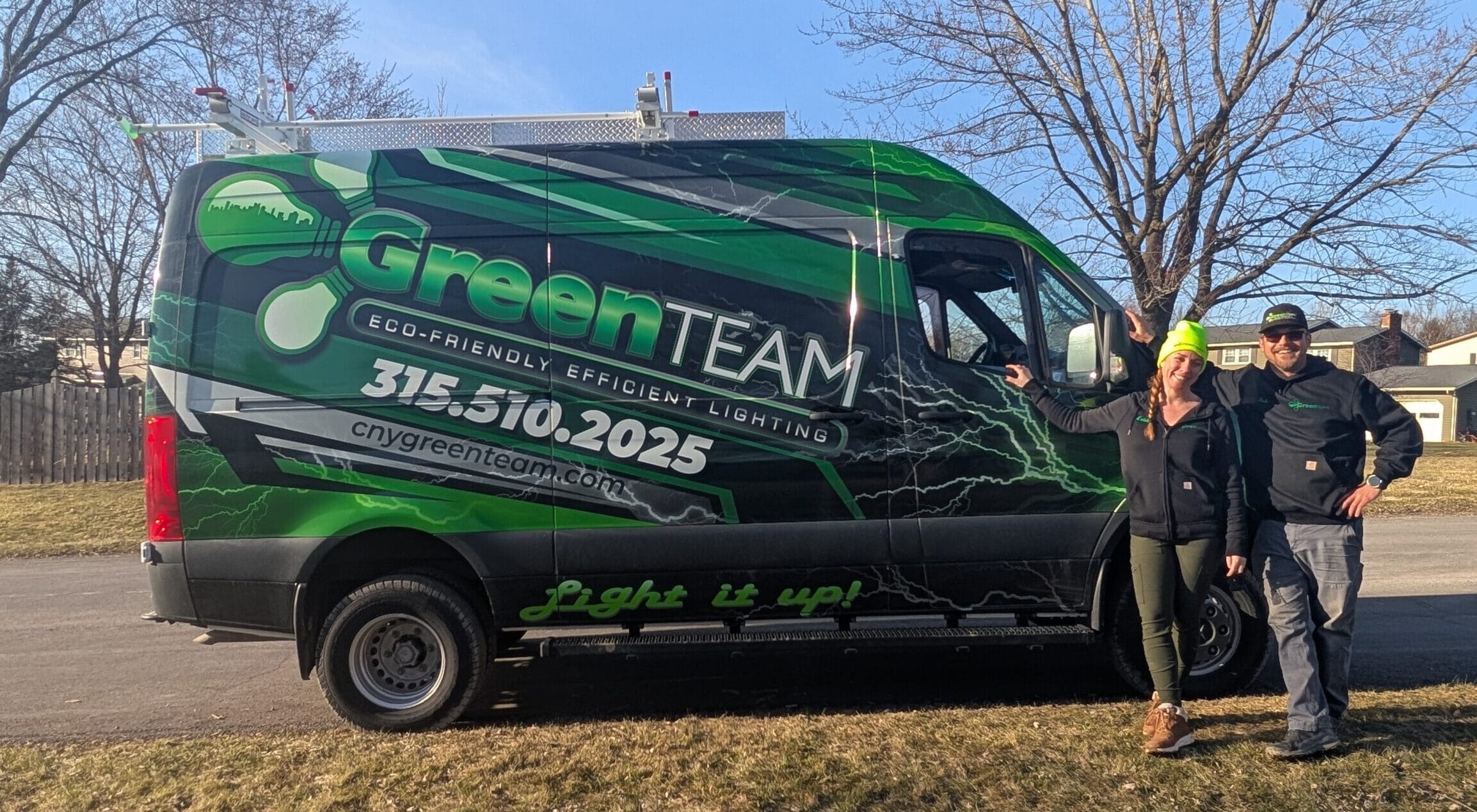 Kristin and Nate standing together next to Green Team Van outside