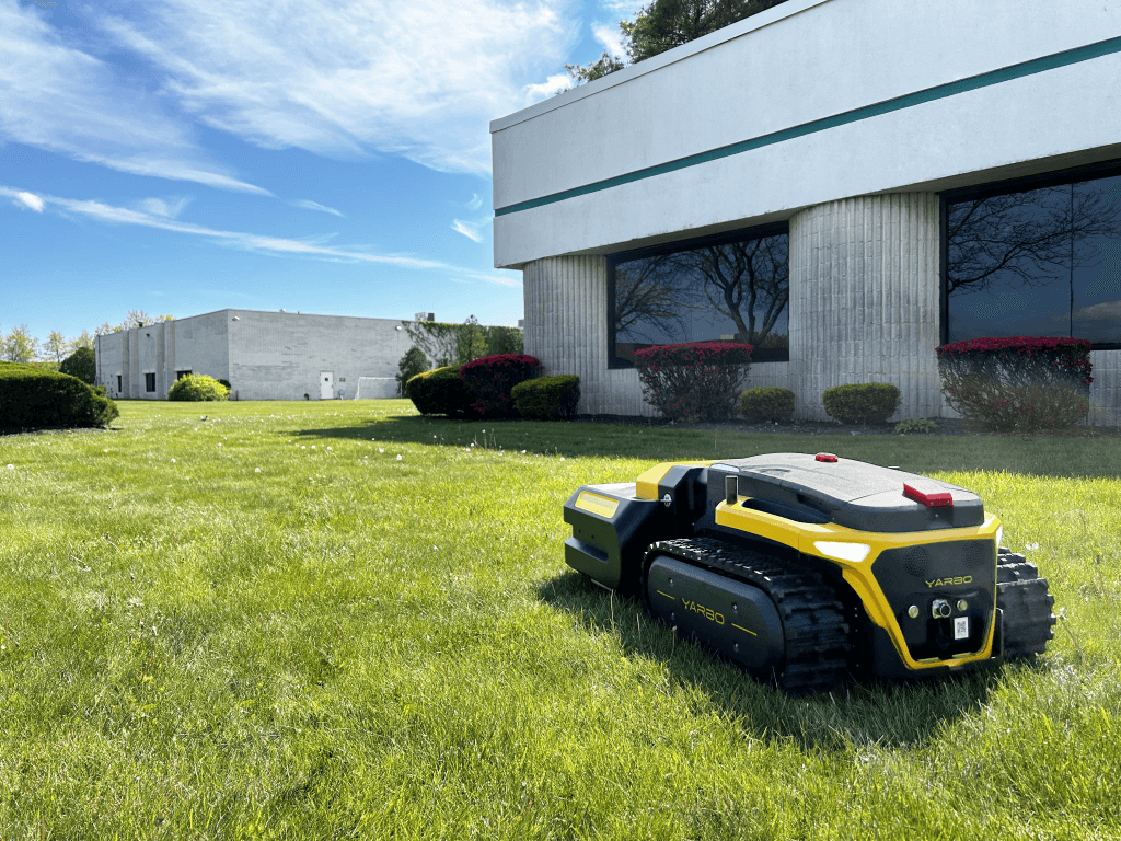 Yarbo Pro Mower maintaining the lawn outside a commercial building.