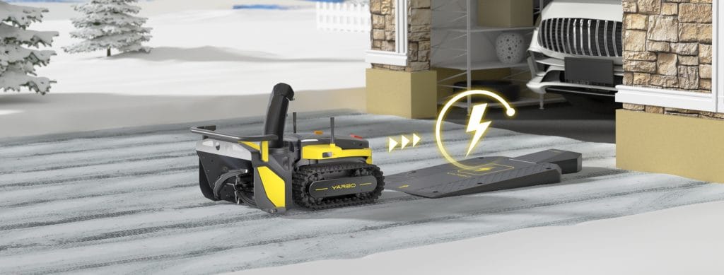 Yarbo robotic snow blower returning to its driveway charging dock with an illustrated power symbol indicating automatic recharging.